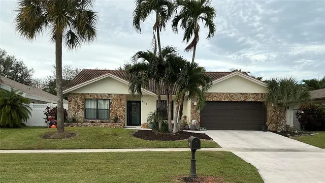 a front view of a house with garden