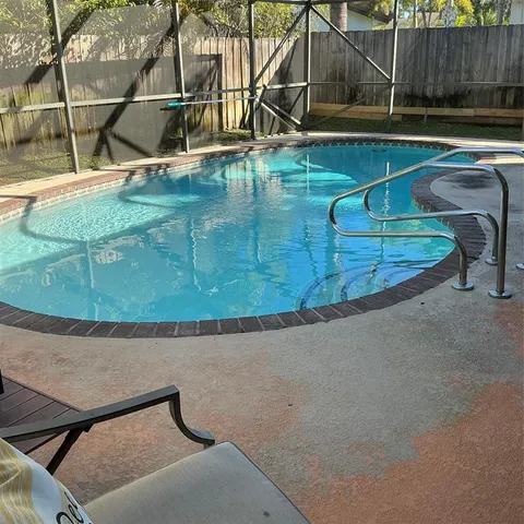 a view of a patio with a table and chairs