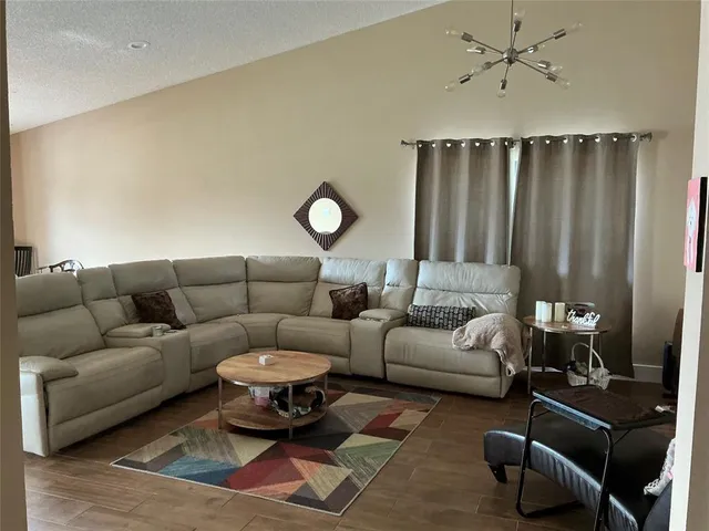 a living room with furniture a rug and a window