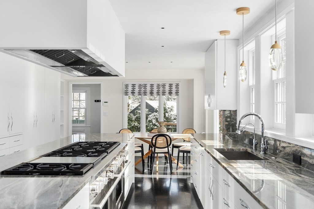 35 Wykeham Road Newton, MA 02465 - Photo 16 of 40 a kitchen with granite countertop a stove a sink and a refrigerator
