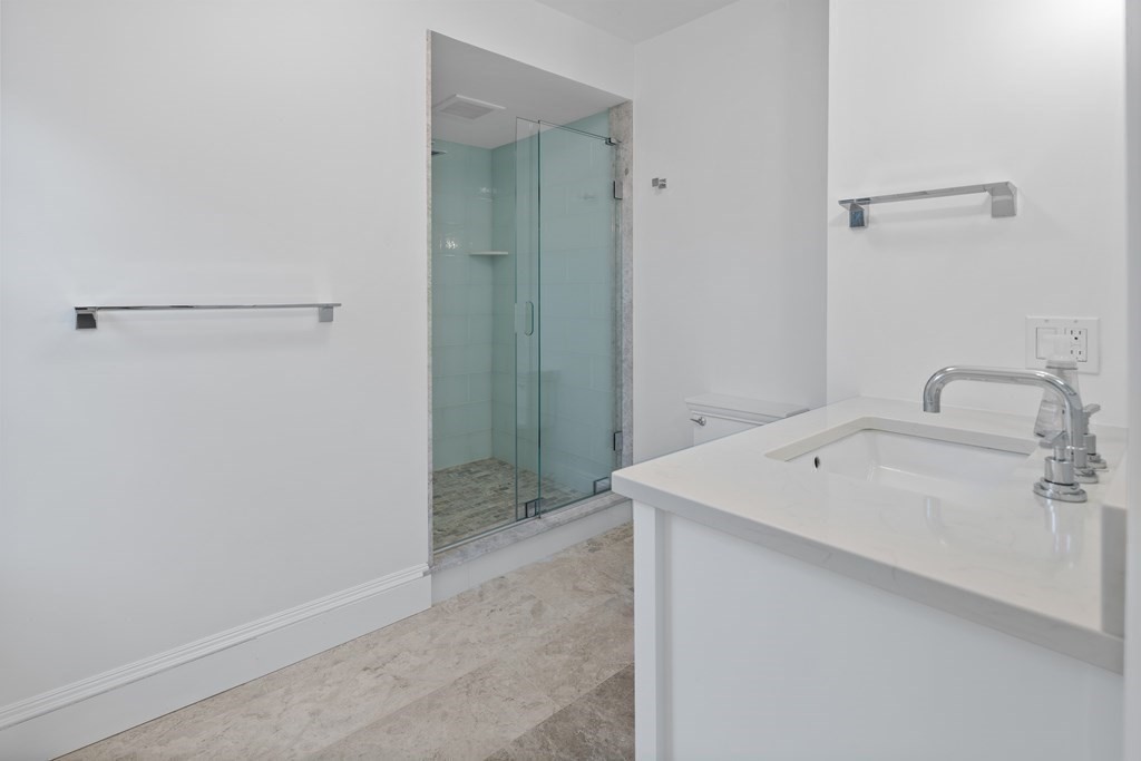 35 Wykeham Road Newton, MA 02465 - Photo 28 of 40 a bathroom with a sink and shower