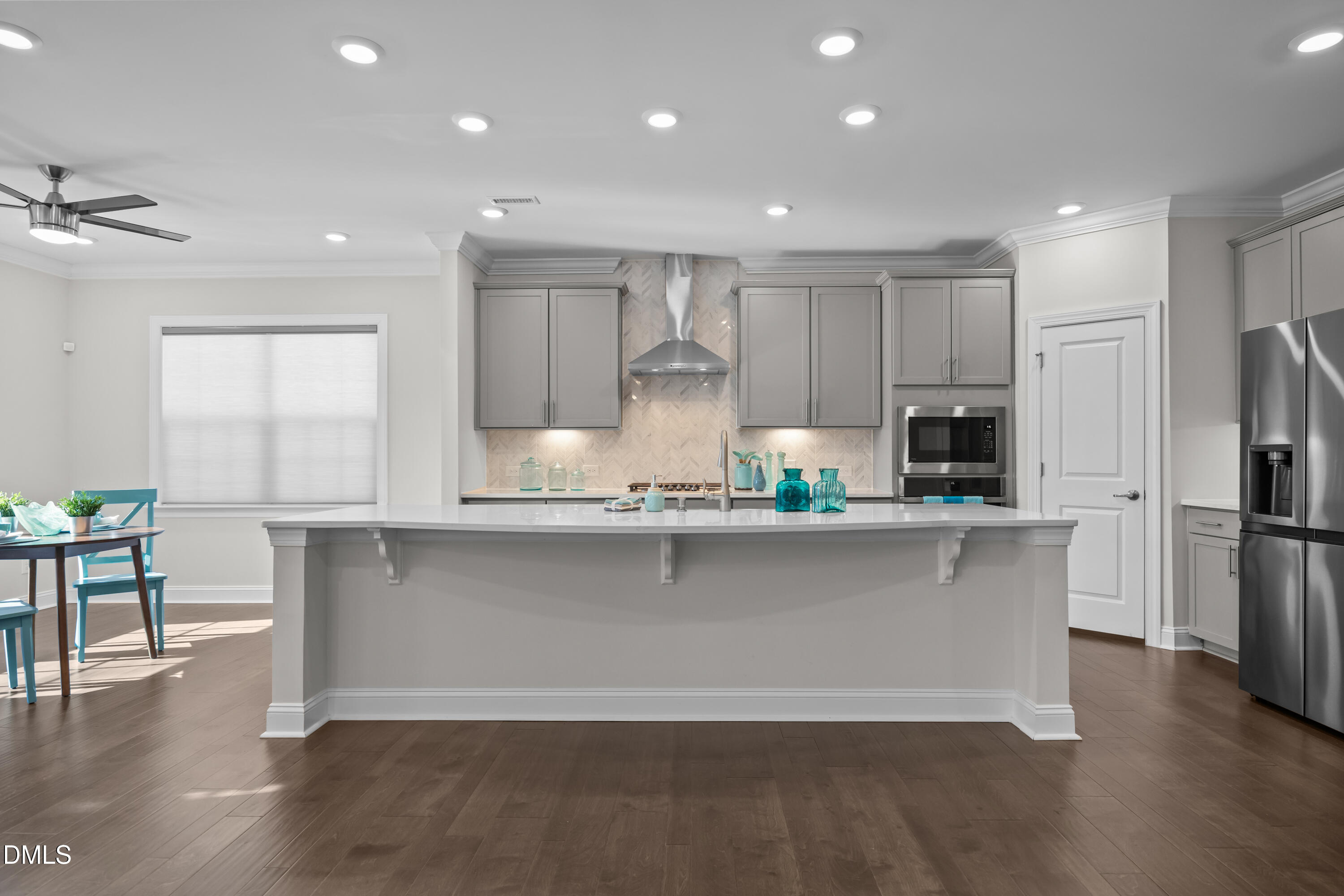 226 English Violet Lane Raleigh, NC 27610 - Photo 18 of 34 a large kitchen with stainless steel appliances a large counter top a stove a refrigerator cabinets and a center island