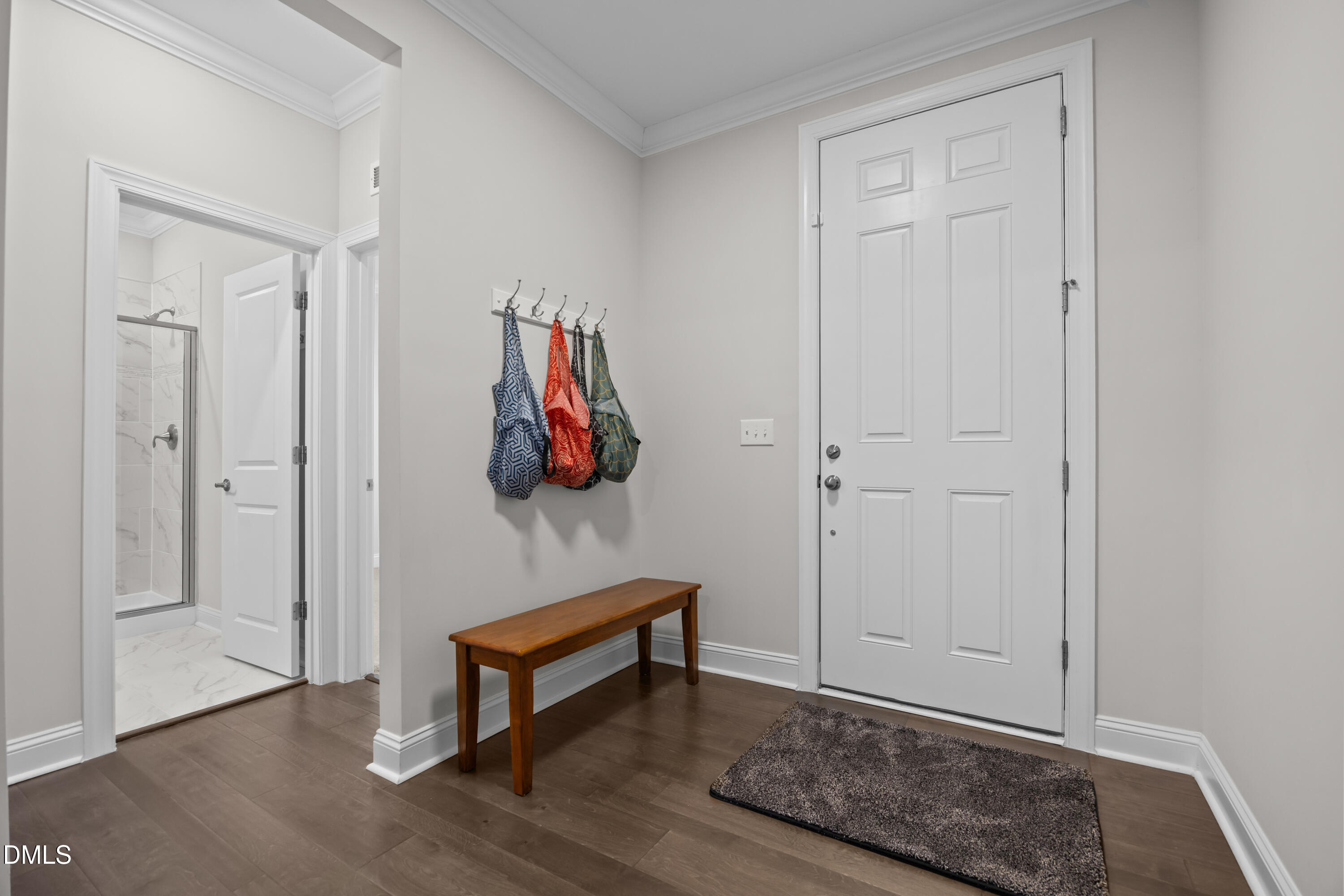 226 English Violet Lane Raleigh, NC 27610 - Photo 4 of 34 a hallway with wooden floor and couch