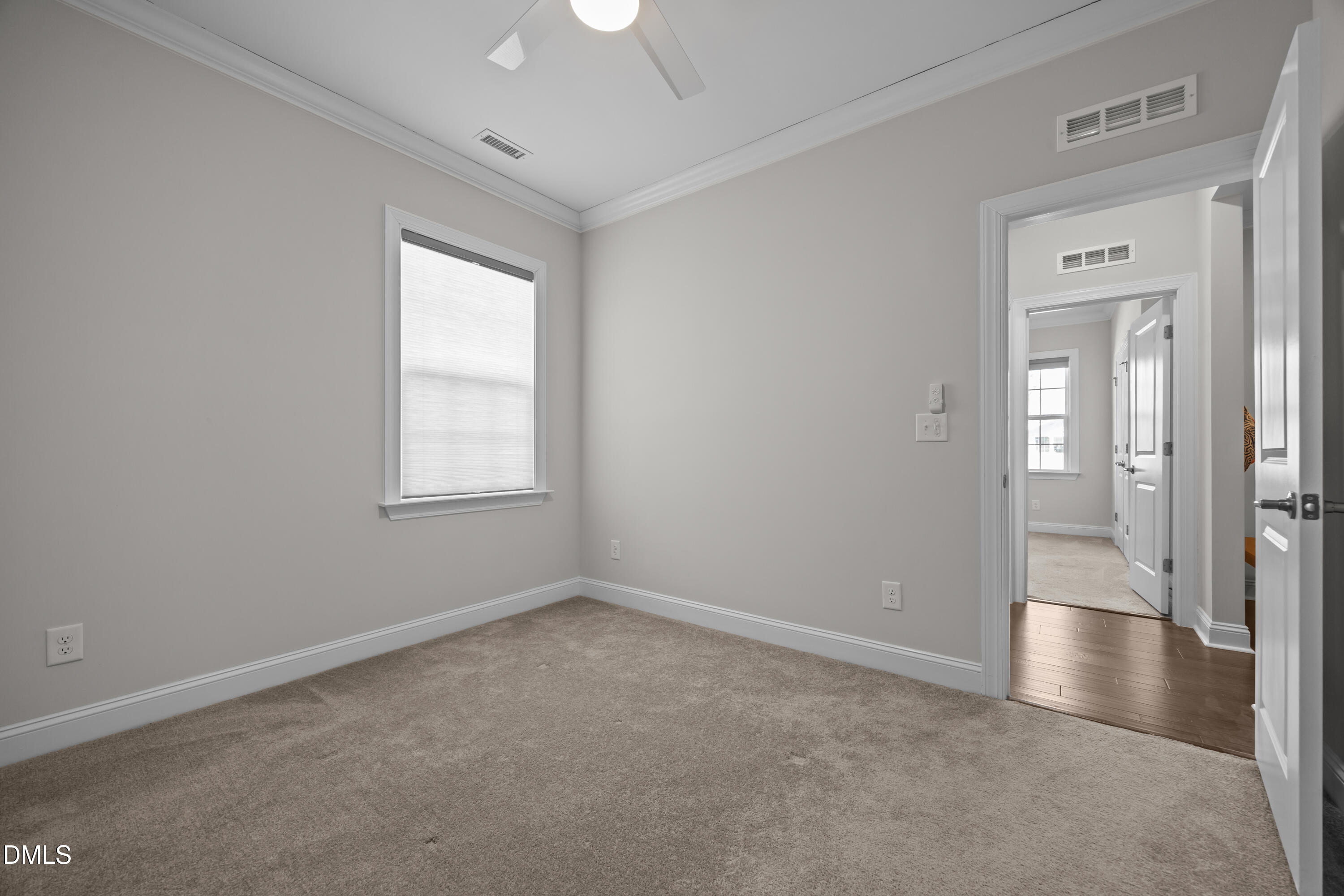 226 English Violet Lane Raleigh, NC 27610 - Photo 8 of 34 a view of an empty room with wooden floor and a window