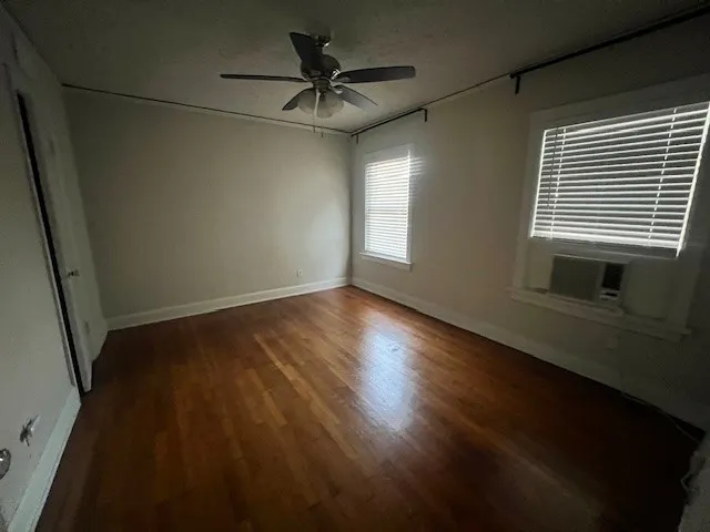 a view of room with window and wooden floor