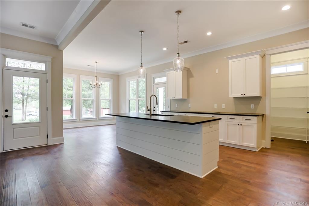 846 Union New Hope Road Gastonia, NC 28056 - Photo 11 of 41 a large kitchen with stainless steel appliances kitchen island a large counter top and a wooden floors