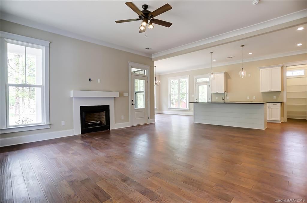 846 Union New Hope Road Gastonia, NC 28056 - Photo 7 of 41 a view of a livingroom with a fireplace a ceiling fan and wooden floor
