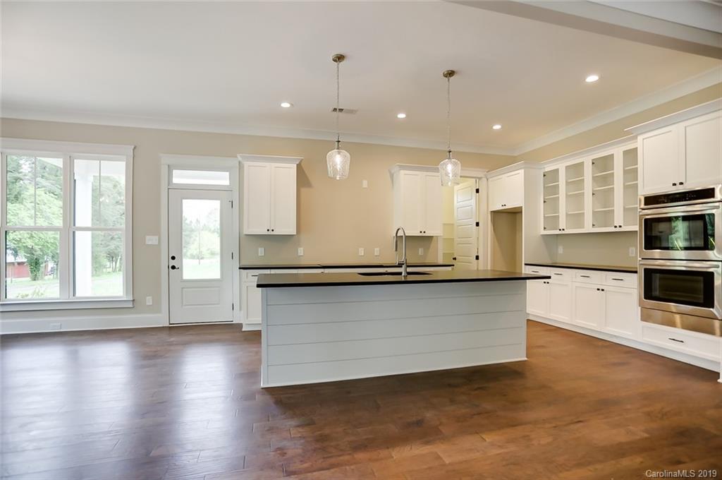 846 Union New Hope Road Gastonia, NC 28056 - Photo 9 of 41 a large kitchen with stainless steel appliances granite countertop a large counter top and a wooden floor