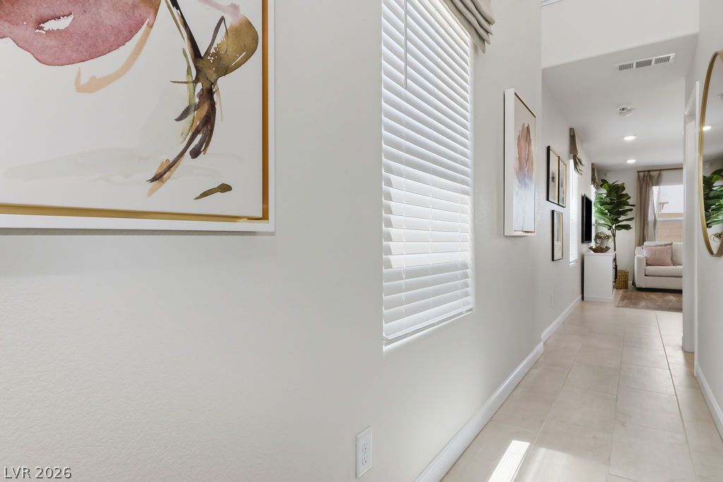 913 Cadence View Way Henderson, NV 89011 - Photo 10 of 46 Sun-kissed hallways lead the way through this bright, inviting interior space.