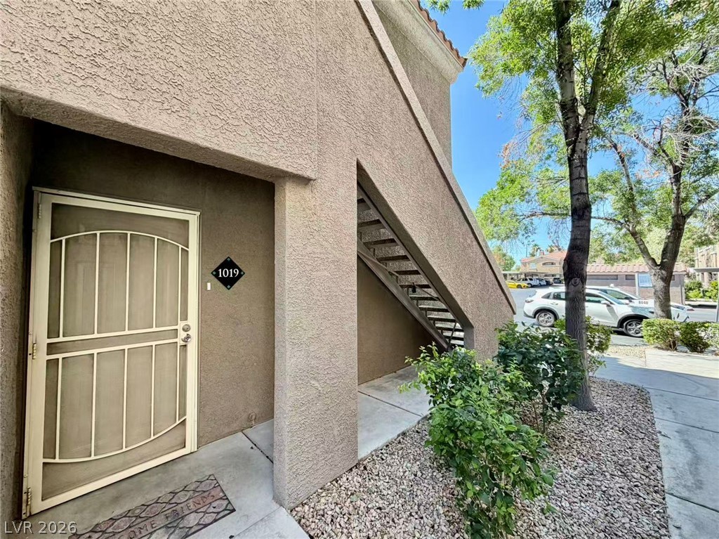 5525 West Flamingo Road, Unit 1019 Las Vegas, NV 89103 - Photo 2 of 18 Secure entry greets residents in this welcoming multi-unit exterior, framed by vibrant foliage.
