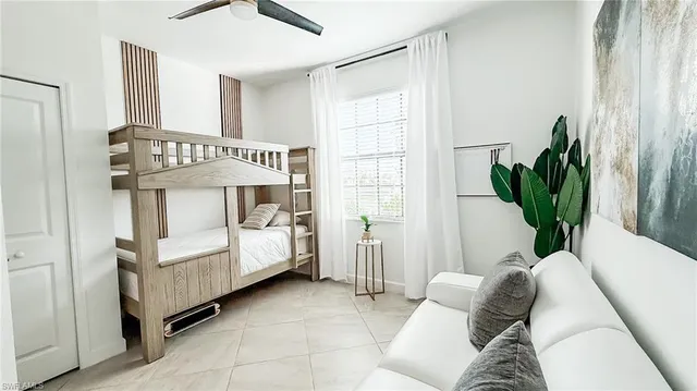 a bedroom with furniture and a potted plant
