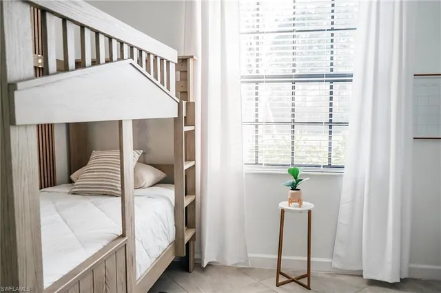 a view of a bedroom with furniture and windows