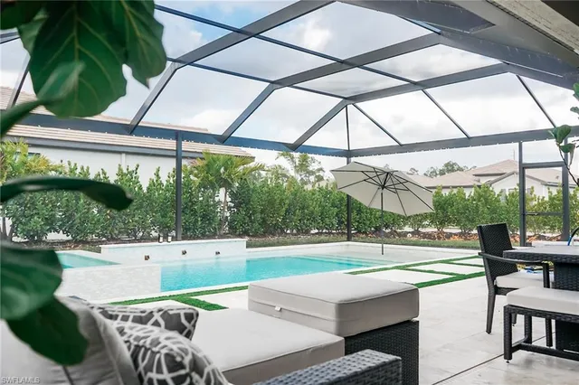a view of a patio with a table and chairs under an umbrella
