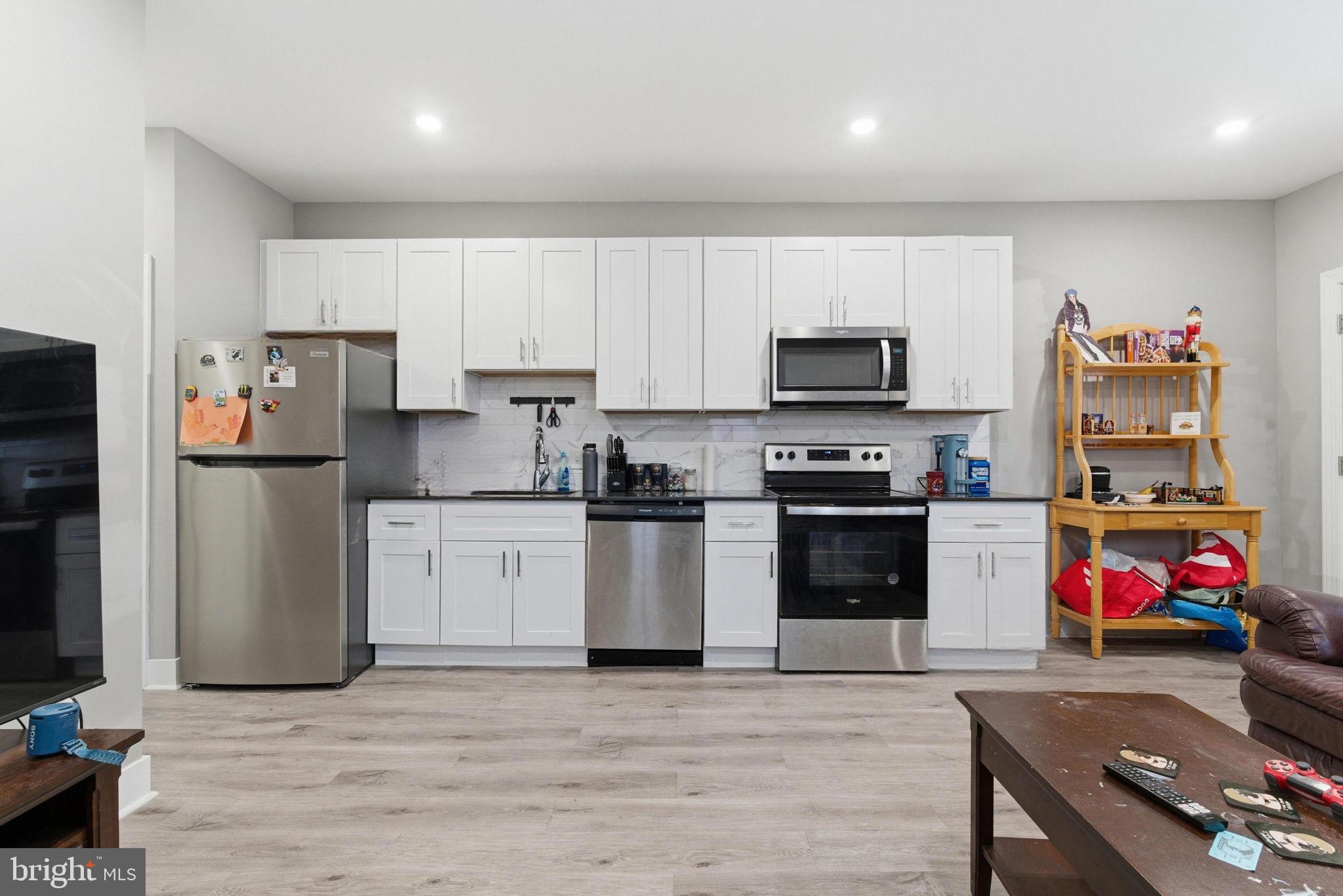 1813 South 23rd Street Philadelphia, PA 19145 - Photo 14 of 23 a kitchen with granite countertop a refrigerator stove and microwave