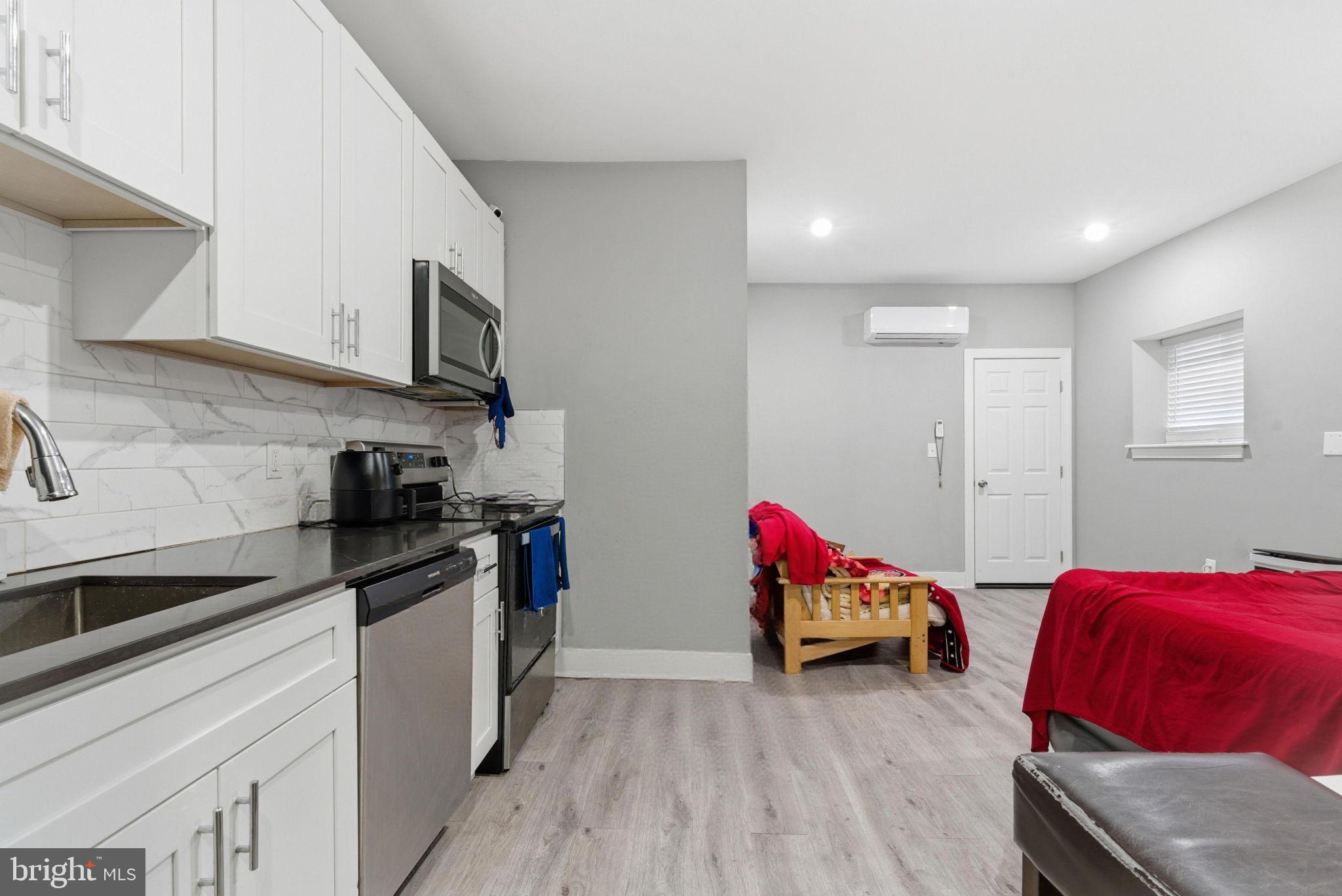 1813 South 23rd Street Philadelphia, PA 19145 - Photo 4 of 23 a living room with furniture and kitchen view