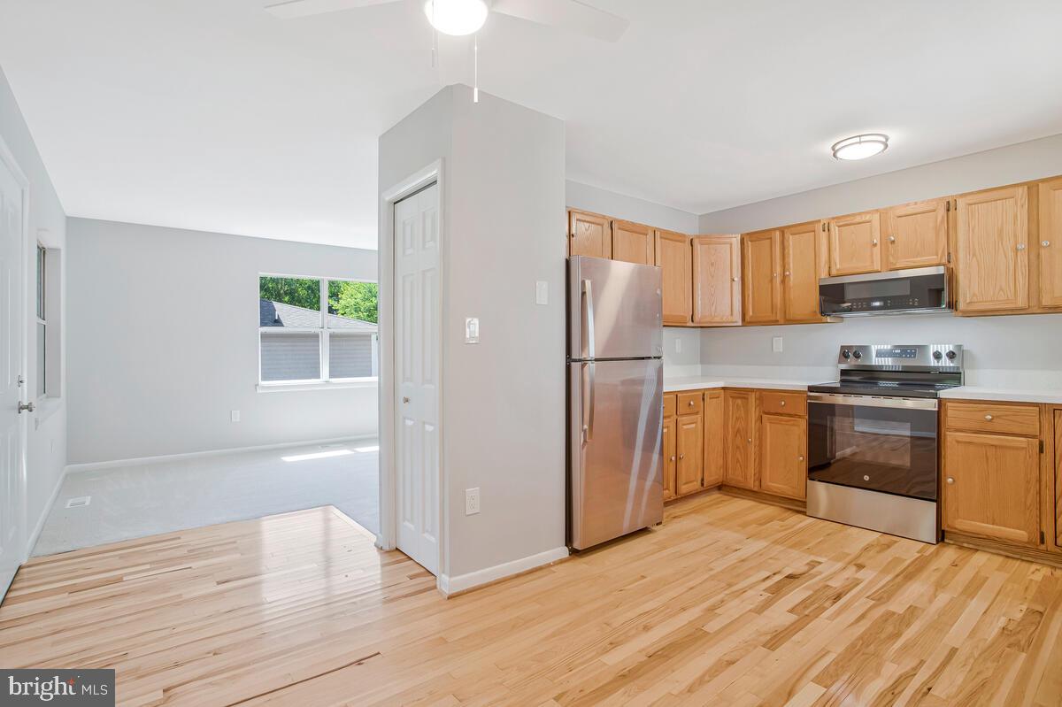251 Cape St John Road Annapolis, MD 21401 - Photo 23 of 61 a kitchen with granite countertop a refrigerator and a stove top oven