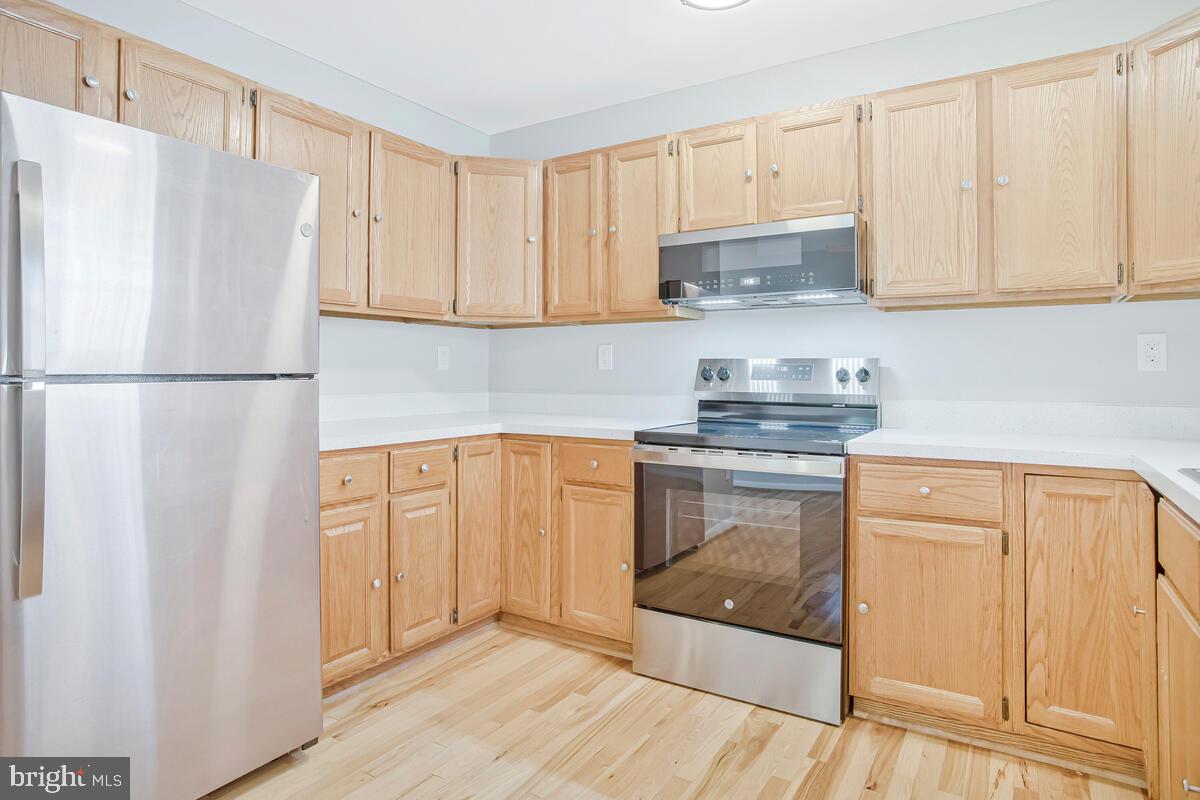 251 Cape St John Road Annapolis, MD 21401 - Photo 25 of 61 a kitchen with granite countertop white cabinets and refrigerator