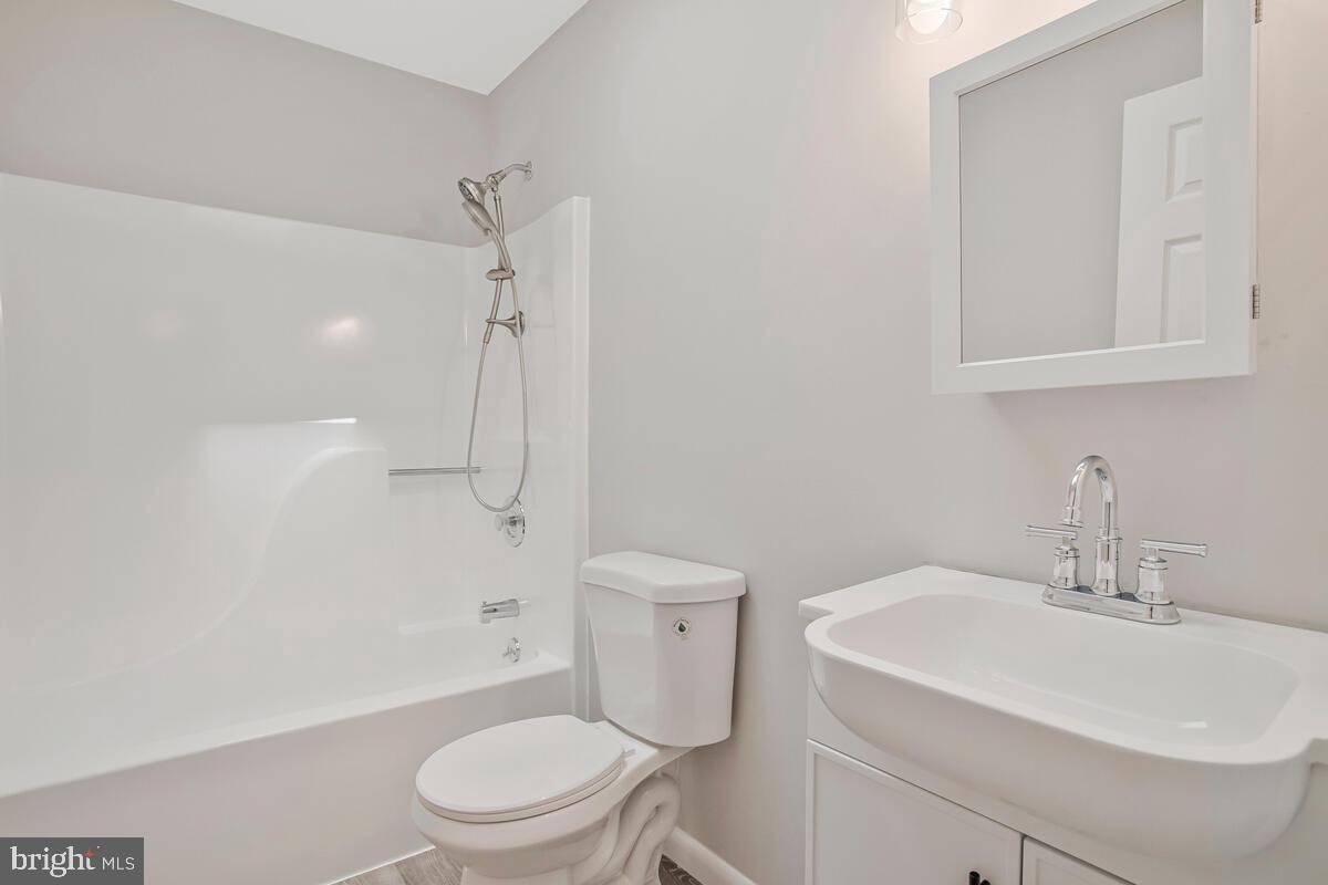 251 Cape St John Road Annapolis, MD 21401 - Photo 35 of 61 a bathroom with a sink a toilet and shower