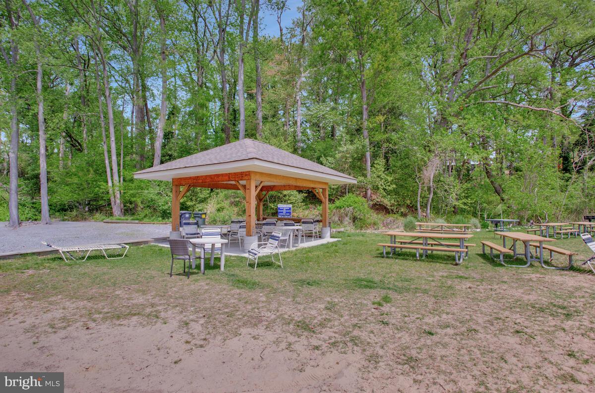 251 Cape St John Road Annapolis, MD 21401 - Photo 49 of 61 a view of backyard with table and chairs under an umbrella
