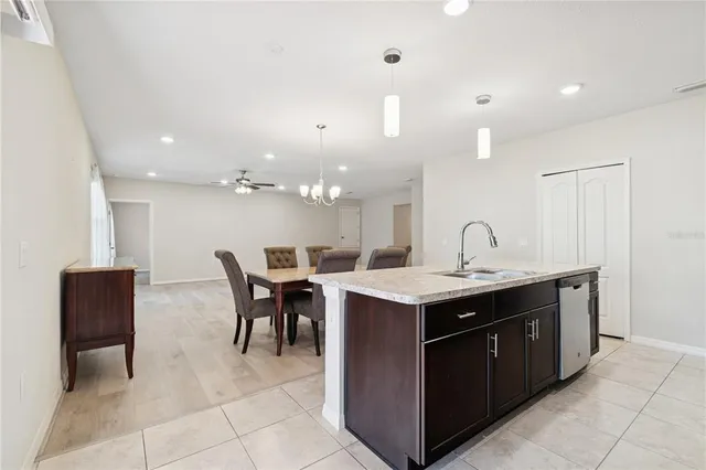 a kitchen with a stove a table and chairs in it