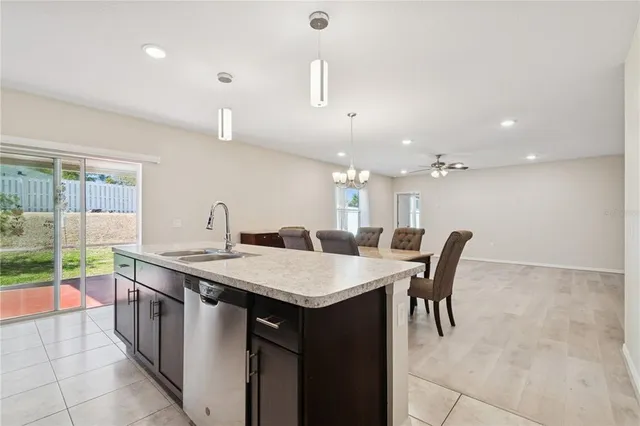 a large kitchen with a table and chairs