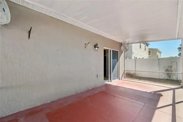 a view of empty room with kitchen natural light and wooden floor