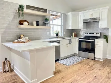 a kitchen with a sink stove and cabinets