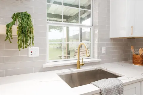 a view of a bathroom with a tub and window