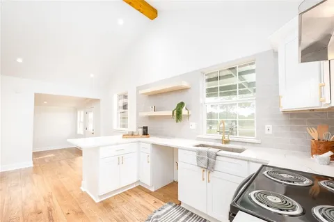 a kitchen with a sink stove and cabinets