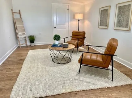 a living room with furniture and wooden floor