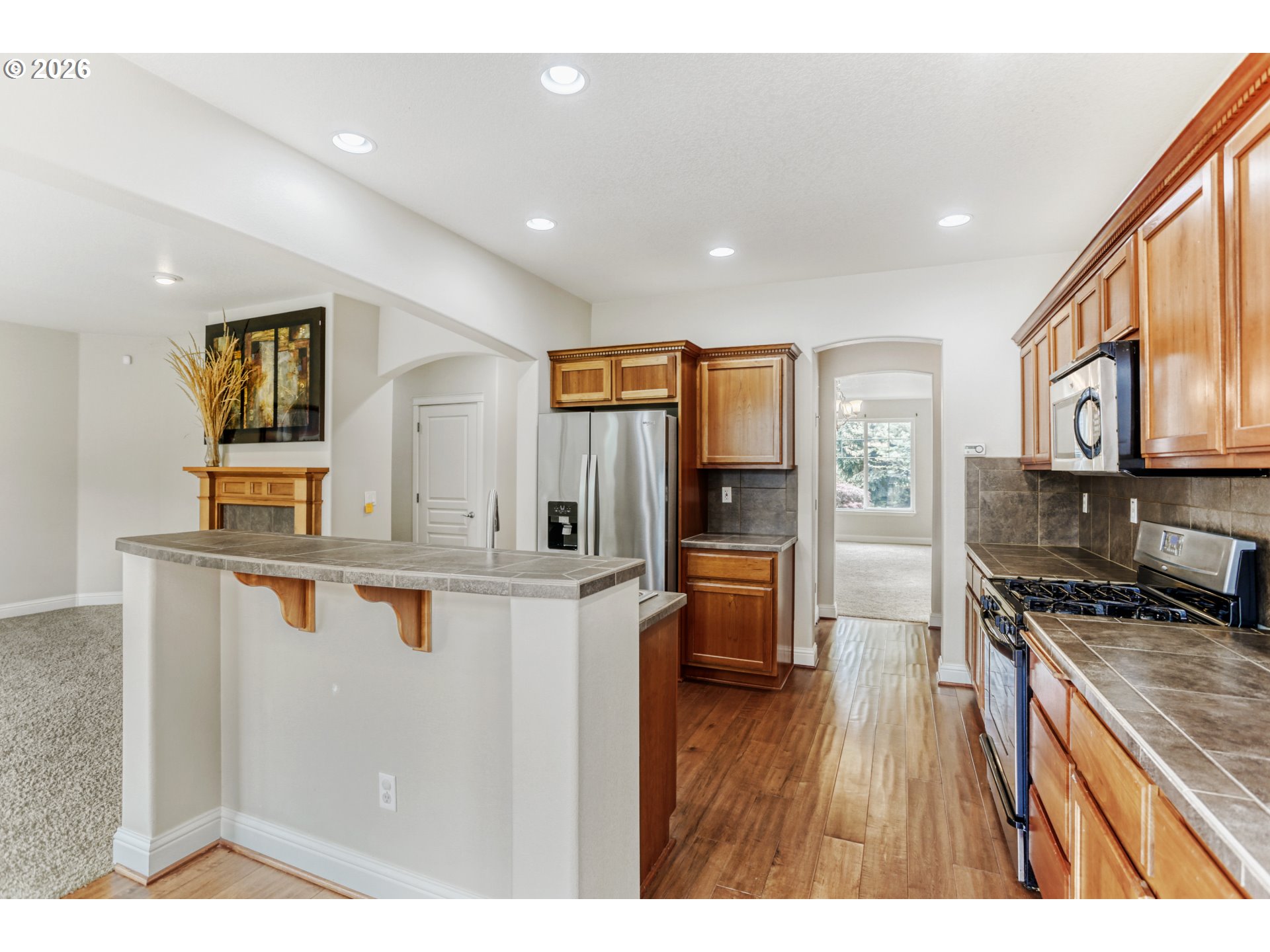 21533 Southwest Susan Lane Beaverton, OR 97003 - Photo 11 of 31 a open kitchen with stainless steel appliances a sink stove and refrigerator