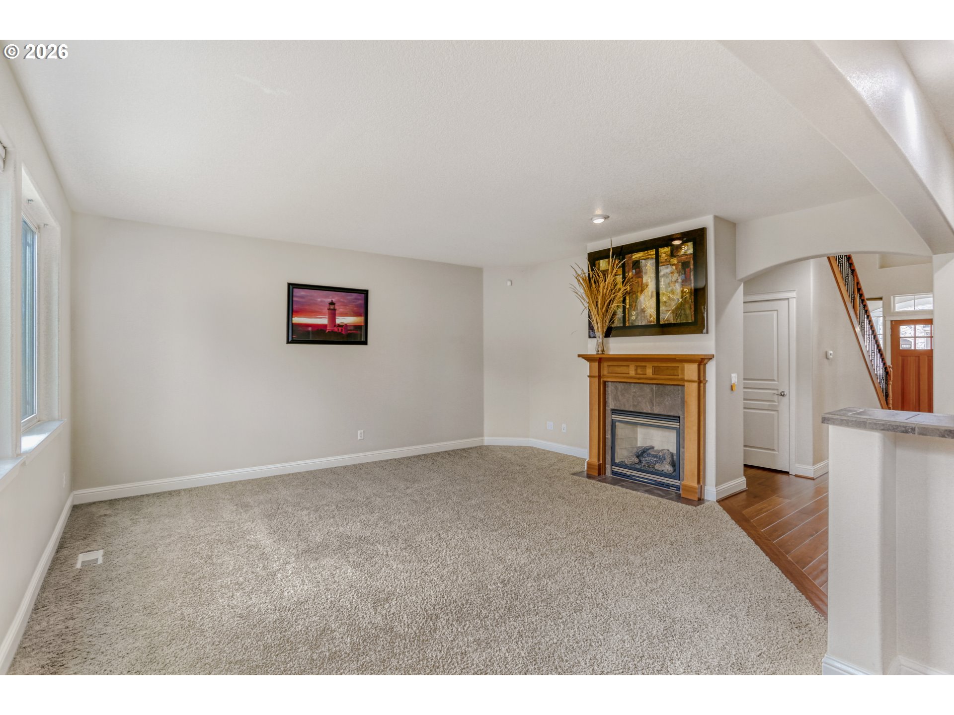 21533 Southwest Susan Lane Beaverton, OR 97003 - Photo 7 of 31 a view of empty room with fireplace and wooden floor