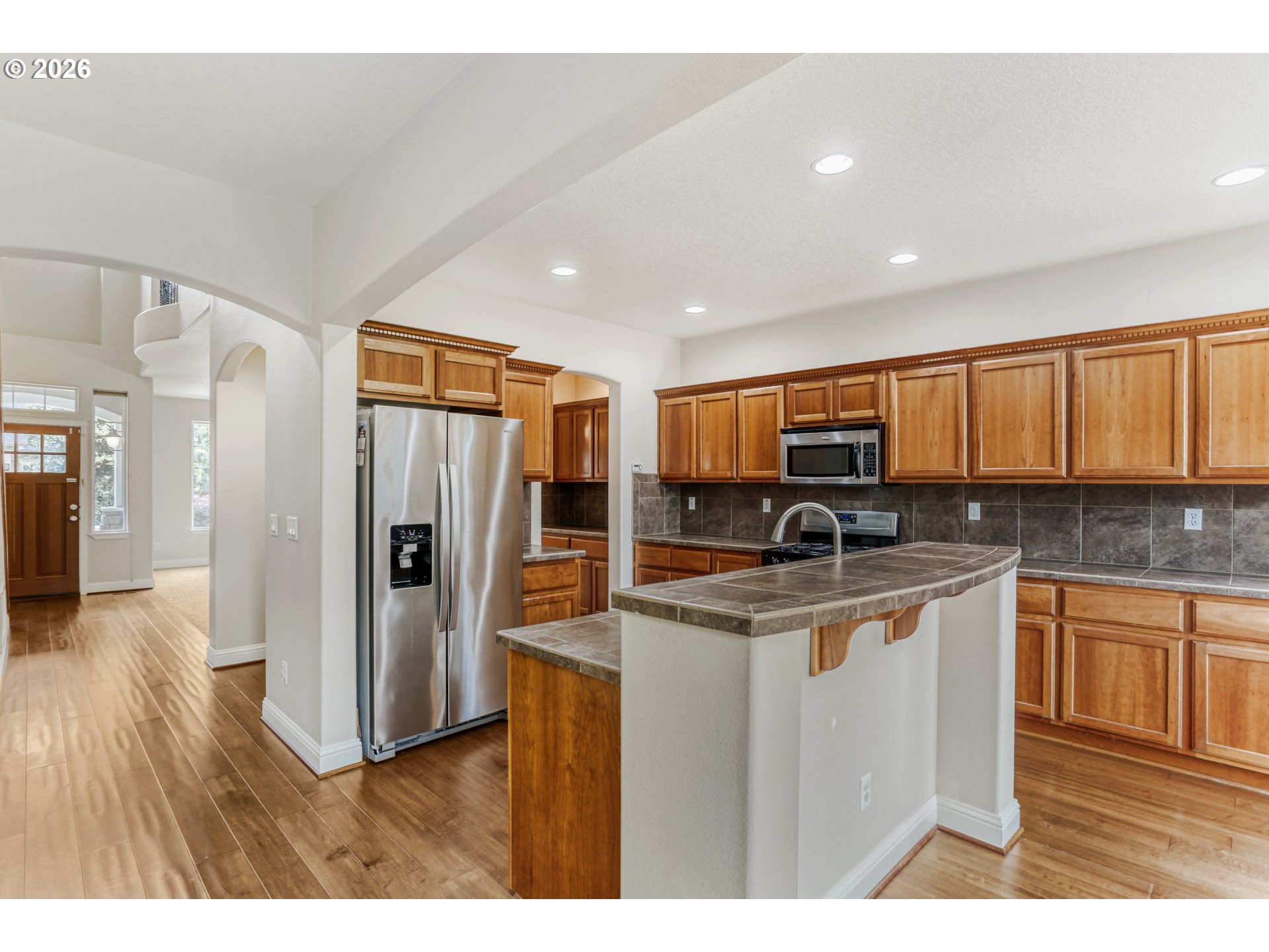 21533 Southwest Susan Lane Beaverton, OR 97003 - Photo 10 of 31 a kitchen with stainless steel appliances granite countertop a refrigerator a stove and a sink