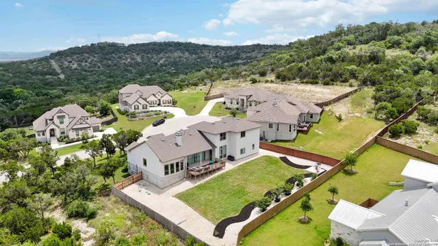 an aerial view of residential house with an outdoor space and seating