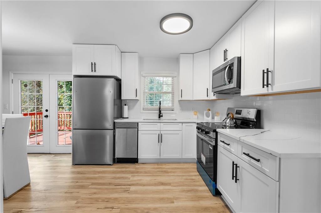 1969 Valley Ridge Drive Southwest Atlanta, GA 30331 - Photo 17 of 37 a kitchen with a refrigerator sink and cabinets