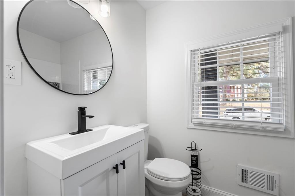 1969 Valley Ridge Drive Southwest Atlanta, GA 30331 - Photo 20 of 37 a bathroom with a sink a mirror and a toilet