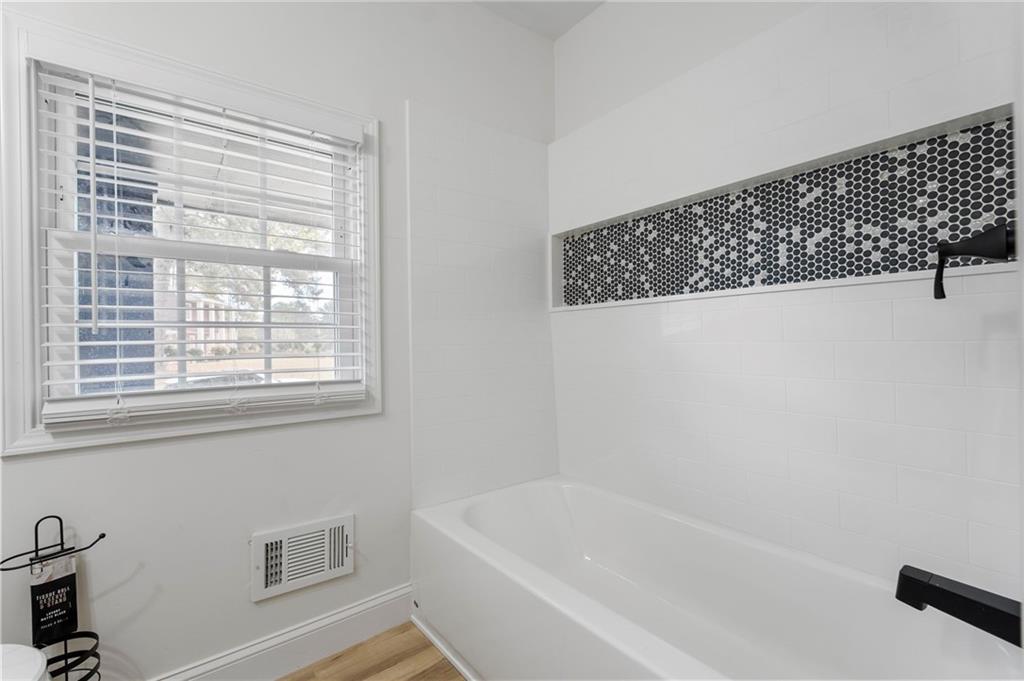 1969 Valley Ridge Drive Southwest Atlanta, GA 30331 - Photo 22 of 37 a bathroom with a bathtub and a shower