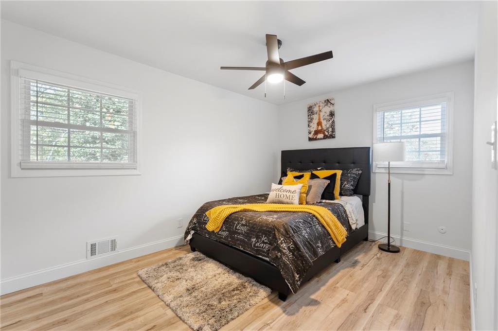 1969 Valley Ridge Drive Southwest Atlanta, GA 30331 - Photo 24 of 37 a bedroom with a bed and wooden floor