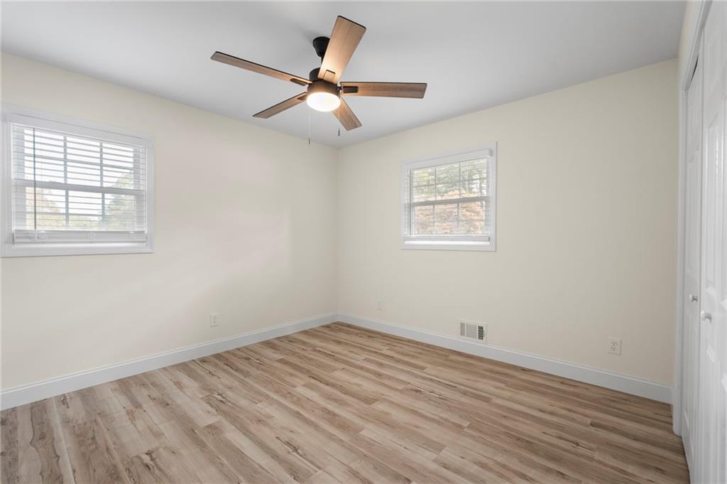 1969 Valley Ridge Drive Southwest Atlanta, GA 30331 - Photo 26 of 37 an empty room with wooden floor fan and windows