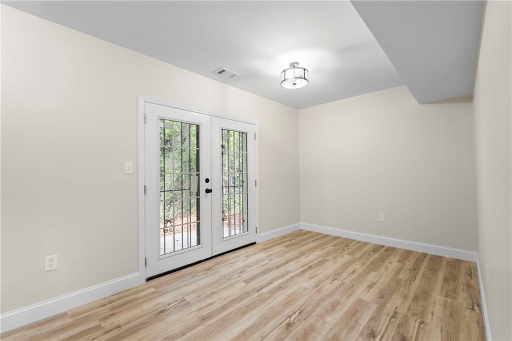 1969 Valley Ridge Drive Southwest Atlanta, GA 30331 - Photo 30 of 37 a view of an empty room with wooden floor and a window