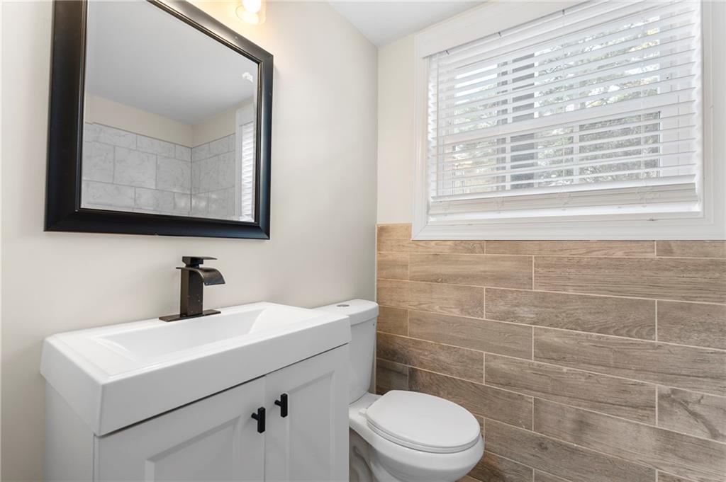 1969 Valley Ridge Drive Southwest Atlanta, GA 30331 - Photo 31 of 37 a bathroom with a sink a toilet a mirror and a window