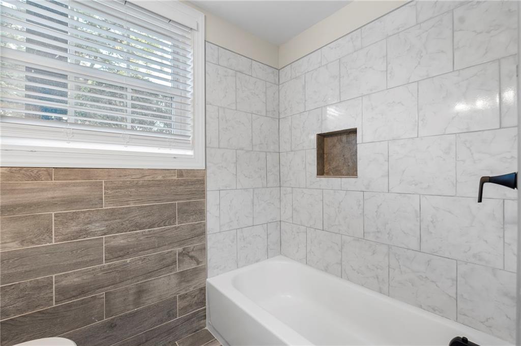 1969 Valley Ridge Drive Southwest Atlanta, GA 30331 - Photo 32 of 37 a bathroom with a bathtub