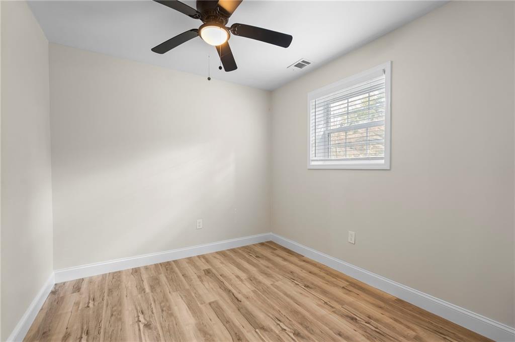 1969 Valley Ridge Drive Southwest Atlanta, GA 30331 - Photo 33 of 37 an empty room with a window and a ceiling fan