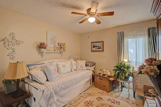 a living room with furniture flowerpot and a chandelier