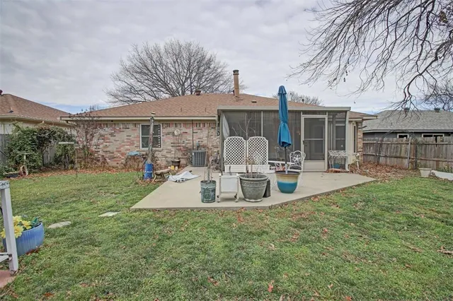 a view of a house with backyard porch and sitting area