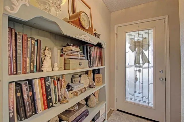 a view of staircase with lots of frames on wall and a window