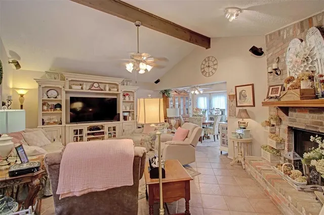 a living room with fireplace furniture and a flat screen tv