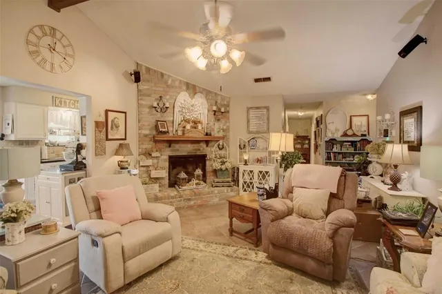 a living room with furniture a fireplace and a chandelier
