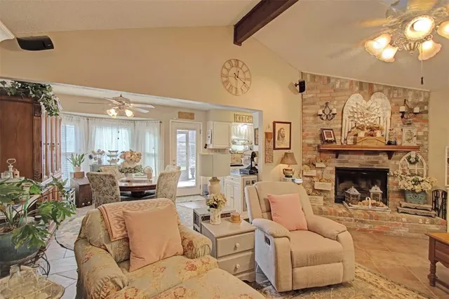 a living room with furniture large window and a fireplace