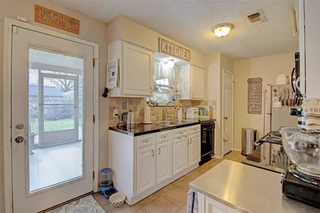 a kitchen with stainless steel appliances sink stove and cabinets